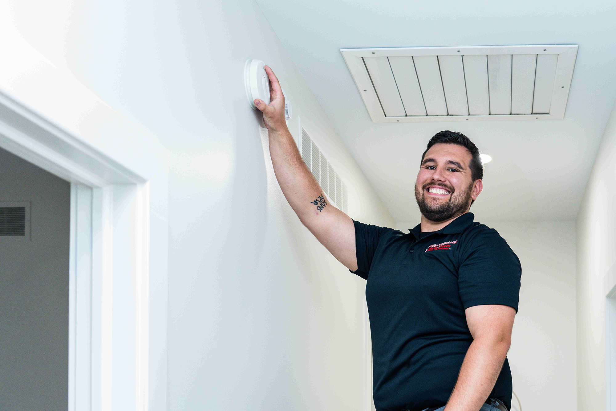 Mrs. Michael electrician installing a smoke detector