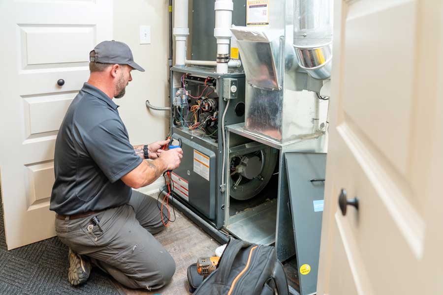 Technician servicing HVAC unit