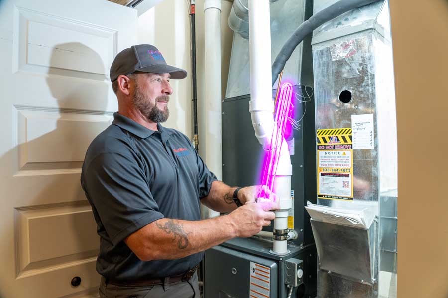 Technician providing indoor air quality solutions