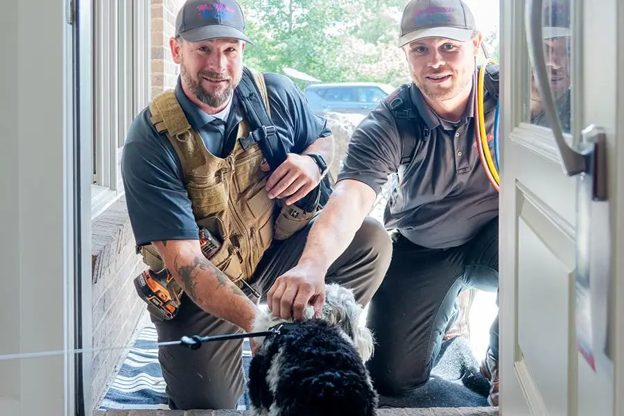 HVAC repair technician in client’s home